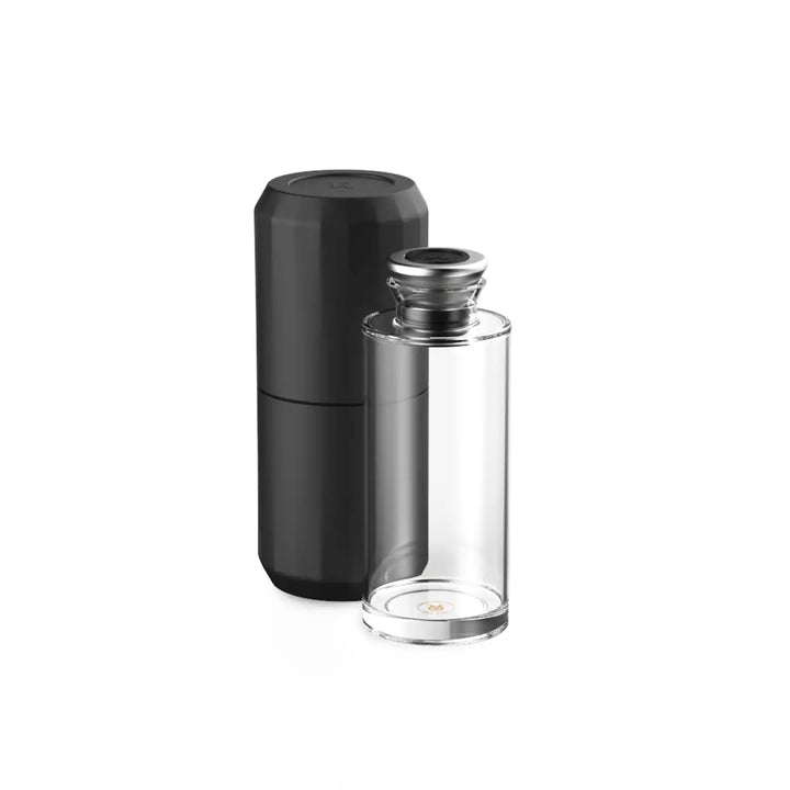 Clear glass bottle with black container.