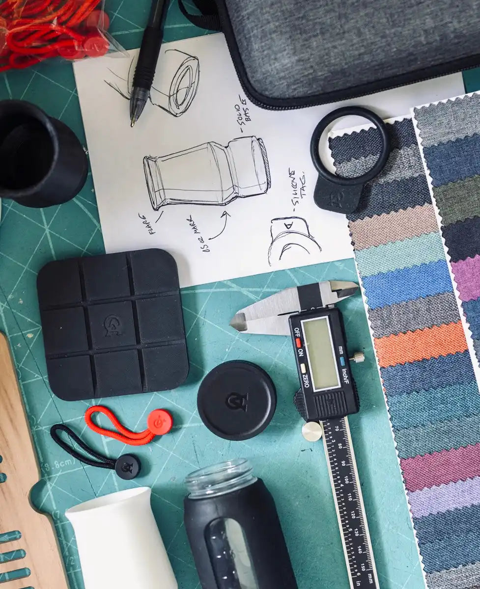 Designer’s workspace with tools and sketches.